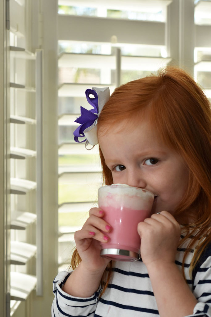 daughter drinking Pink Hot Chocolate Recipe by Happy Family Blog